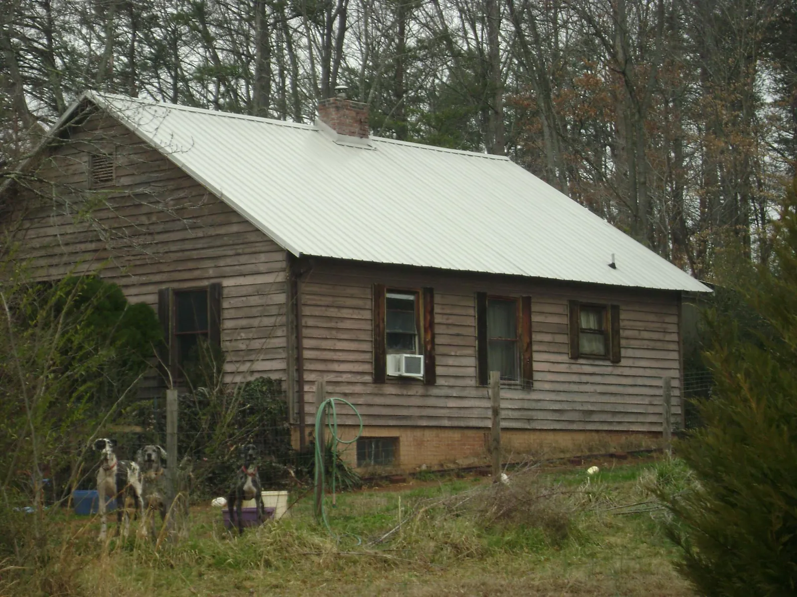 White metal roof on an old wood sided farmhouse, from a Metal Roof Installation job in Hildale